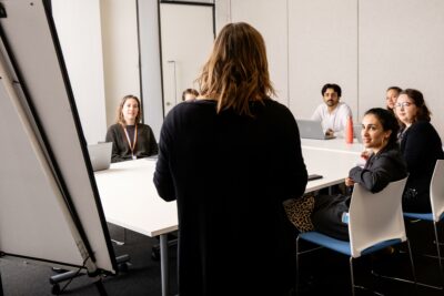 Staff and students in meeting room