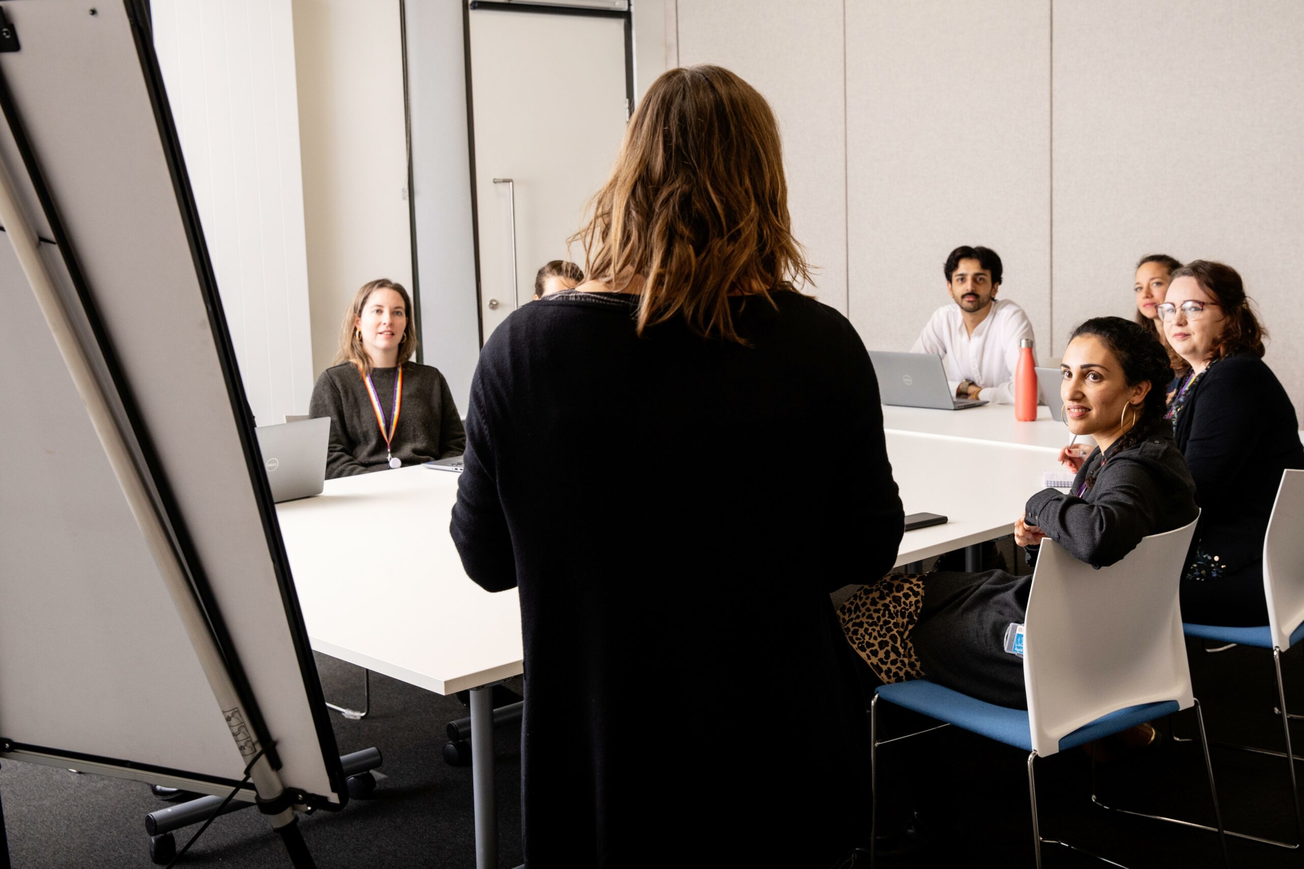 Staff and students in meeting room