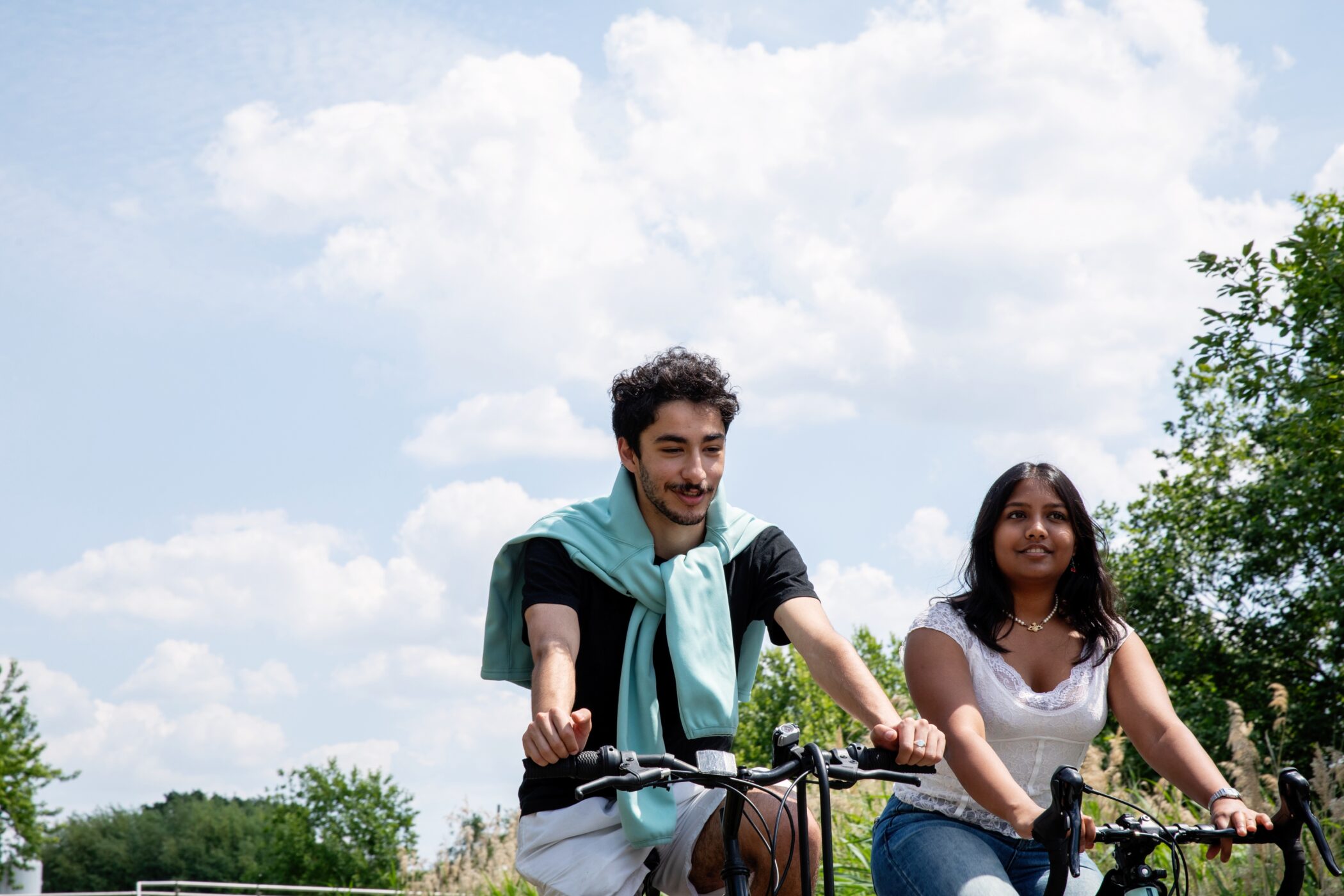 Two University of Cambridge students cycling near the West Café.