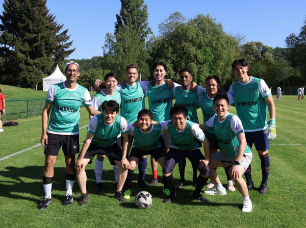 Group photo of the Cambridge football team at MBAT 2025. The individual standing at the far right in the front row is Takumi.