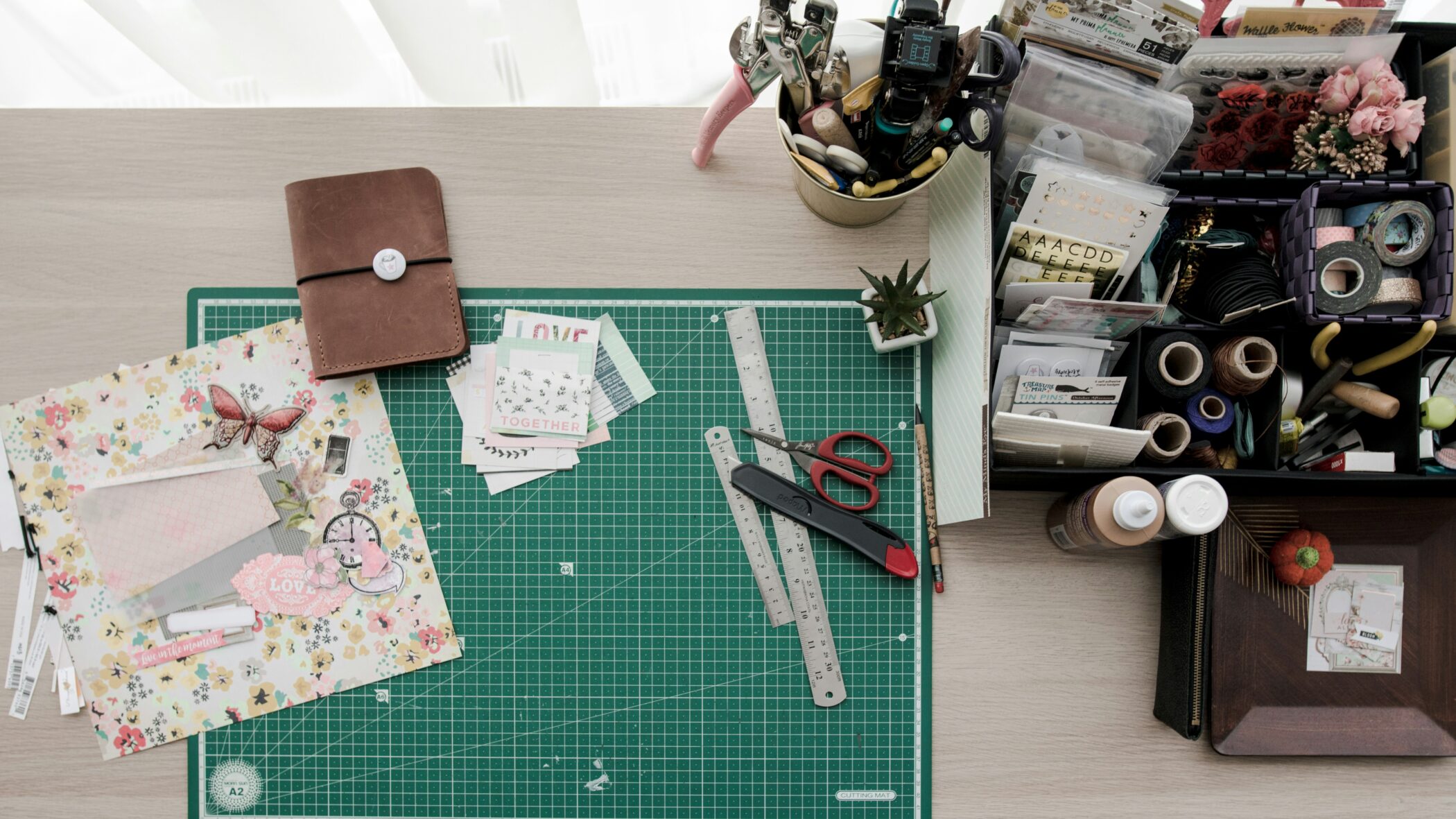 A royalty-free photo of craft materials on a desk taken from above