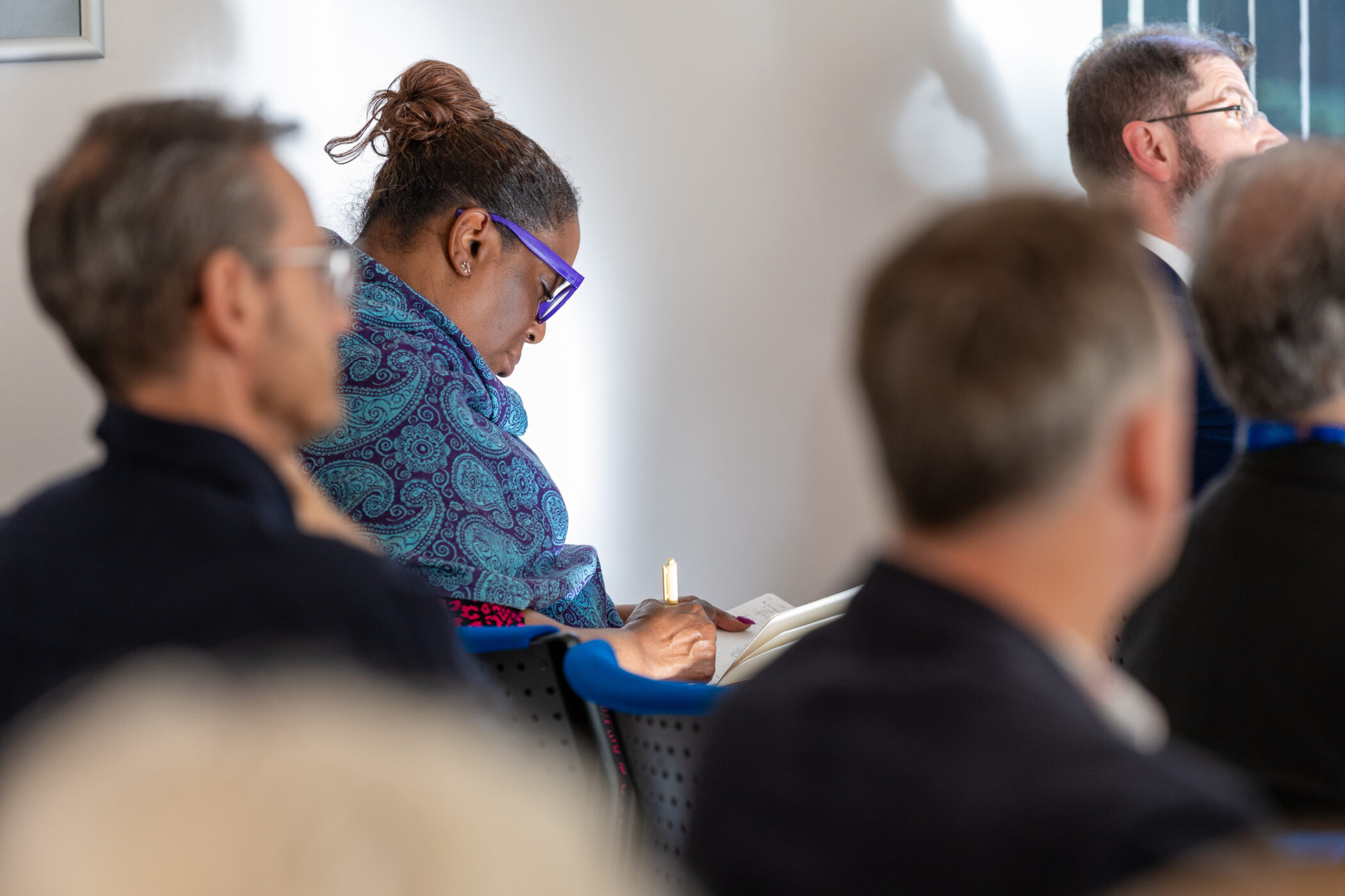 VHi people in audience, woman making notes