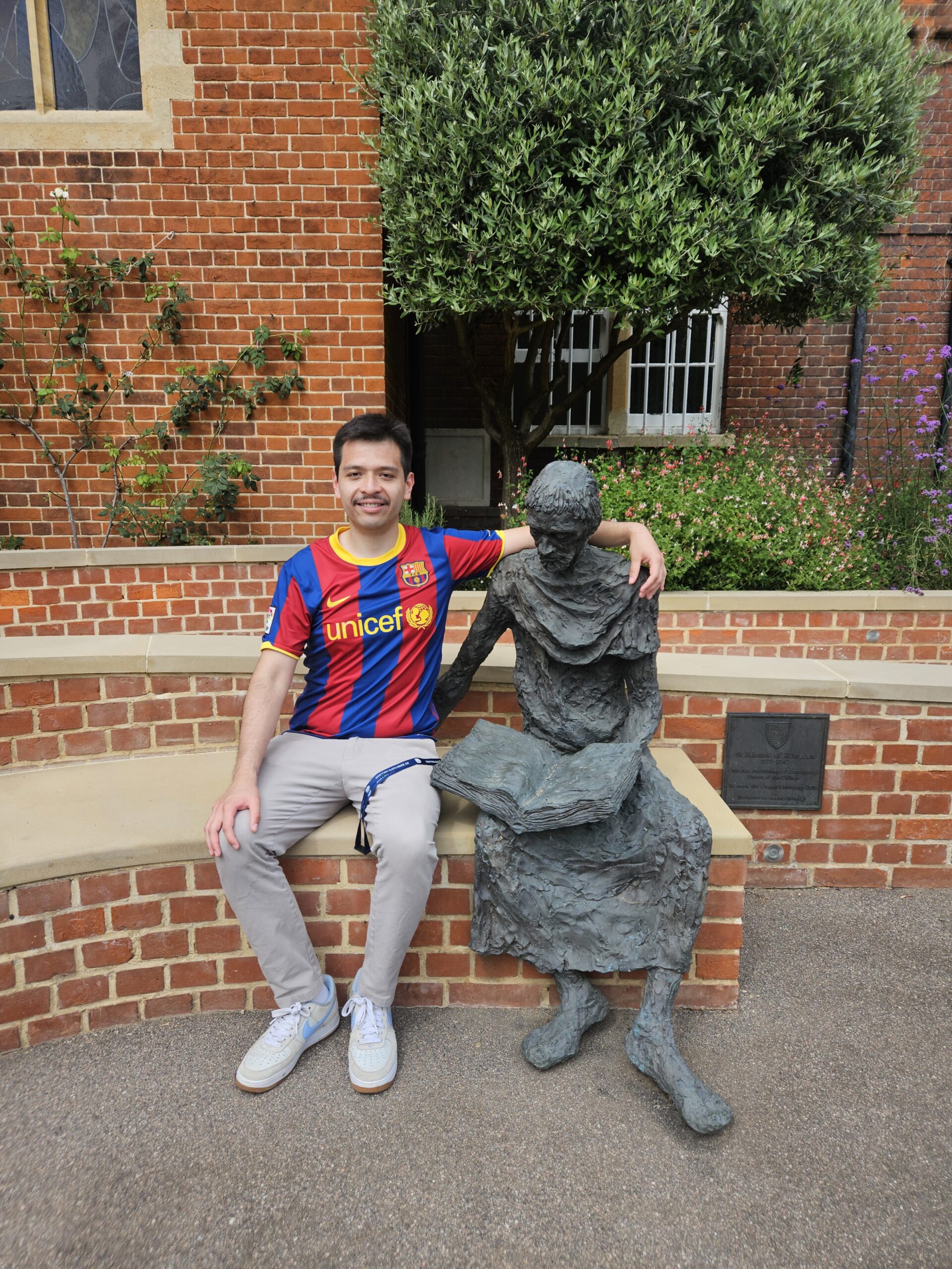 Sebastian Acuy sitting with St Edmund's Statue