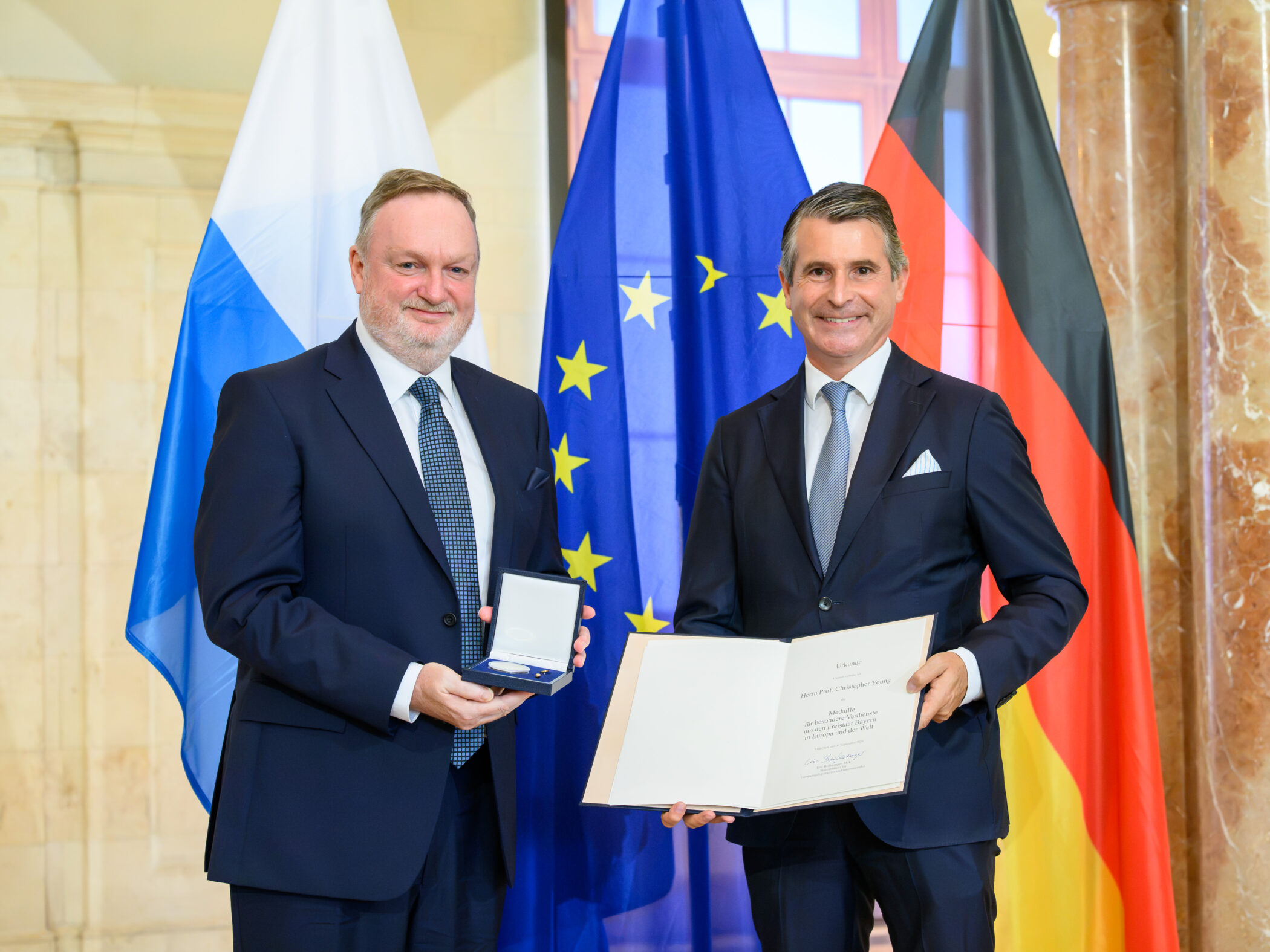 Master holding medal with German official